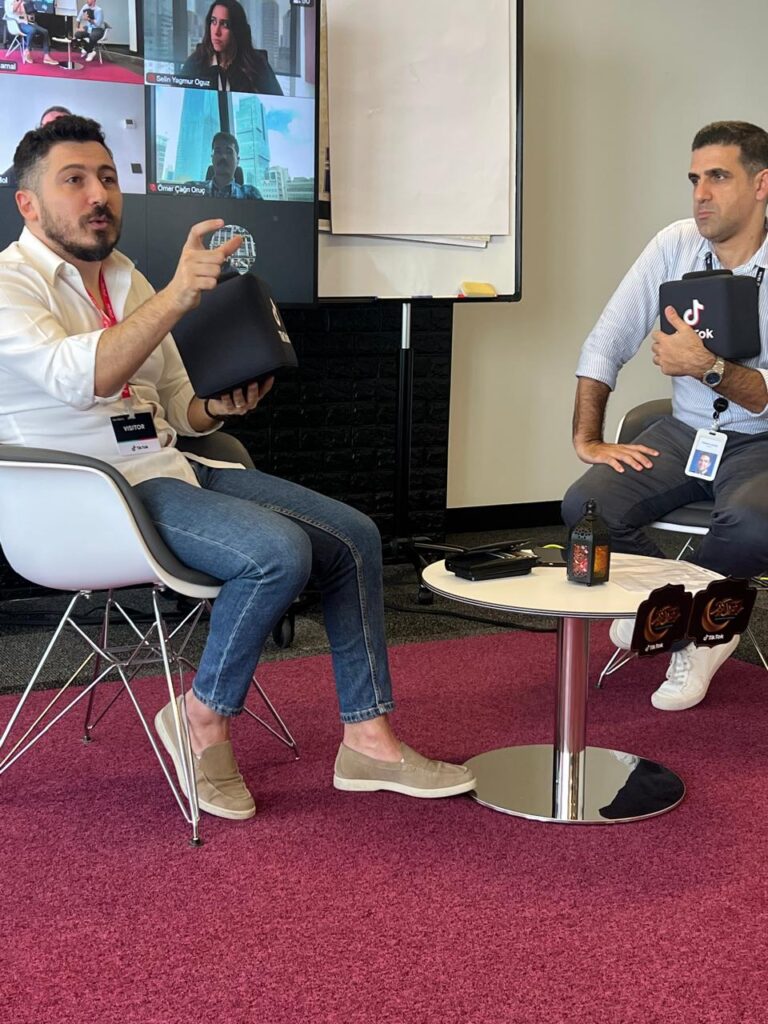 Elie Farhat standing in front of a large digital screen, presenting AI-driven marketing strategies to a corporate audience.